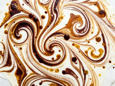 Classic Turkish Ebru stone pattern, tight combed curls in warm earth tones on cr