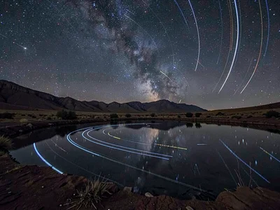 Trails reflected in still desert water
