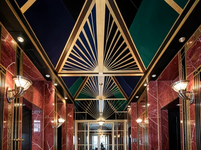 A Chrysler Building lobby detail: the triangular ceiling murals, polished red ma