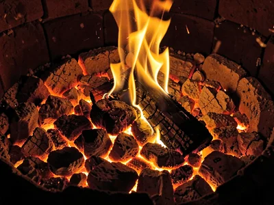 Coal fire showing orange through crack pattern
