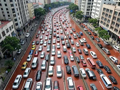 Rush hour traffic from above forming red and white rivers, vehicular circulatory