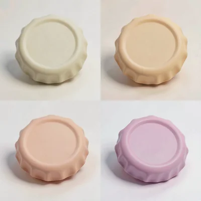 A 2x4 grid of abstract bottle-cap mockups in soft warm tones, caps slightly tilt