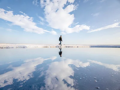 Person walking on sky literally through reflection