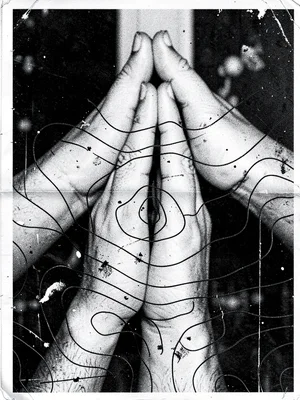 Overlapping xeroxed hands in prayer position layered with topographic map contou