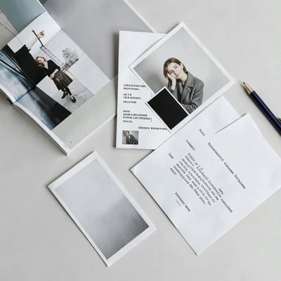 A scattered desk overhead with abstract editorial-design collateral — magazine,