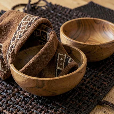 Warm tapa cloth browns and geometric pattern rhythm, Wooden bowls nested togethe