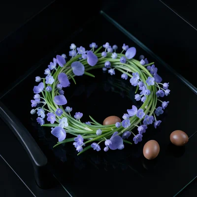 Pressed spring flowers — violets, forget-me-nots, lily of the valley — arranged 
