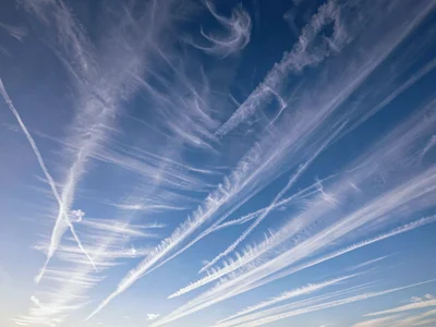 Cirrus wisps arranged in parallel streaks across gradient sky