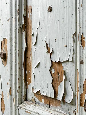Peeling paint on old door revealing layers and rough edges
