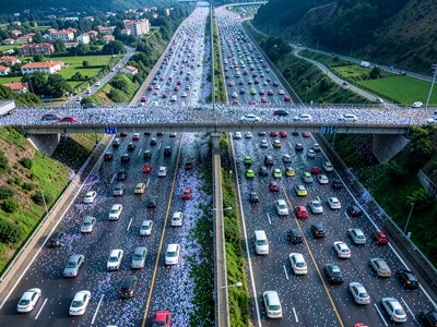 Highway overhead with vehicles dense as particles