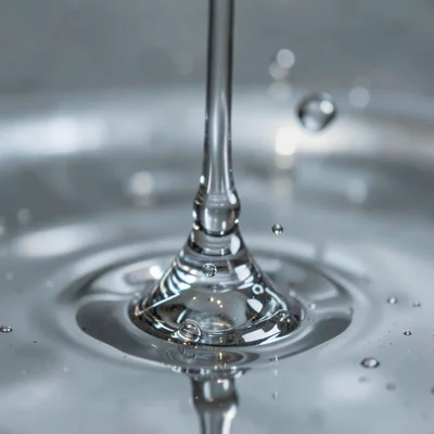 Mercury drops coalescing in slow motion, surface tension pulling them together