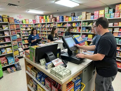 Register checkout, items scanned rapidly, the tally adding up slowly at a dollar