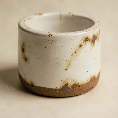 Tight texture study of a tumbler base with smudge halos, single key light