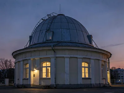 Soviet-era mounting and dome stark against modern sky