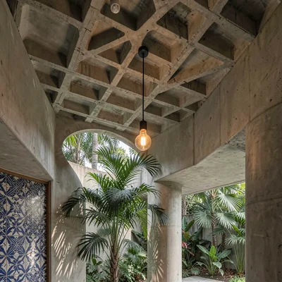 Interior detail — concrete waffle slab ceiling, warm incandescent pendant fixtur