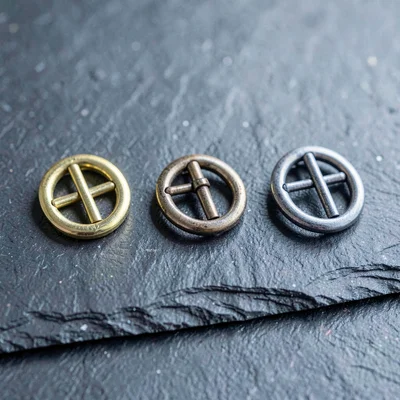 Material swatch study of three buckle finishes, polished brass, antique nickel,