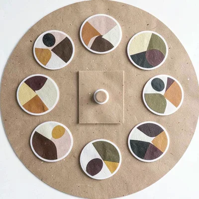 A sticker-sheet circular layout of twelve round die-cut abstract stickers arrang
