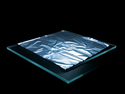 Crumpled aluminum foil smoothed partially flat on the scanner bed, reflecting th