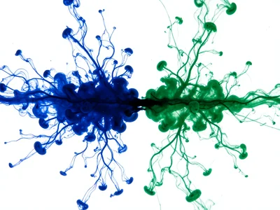 Two inks meeting — indigo blue from left, emerald green from right — collision z