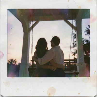 Expired Polaroid instant film photograph, Couple embracing on porch swing at twi