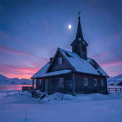 Polar liminal light, extended blue hours, Snow-dusted wooden church in blue hour