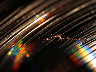 Vinyl scratch under macro magnification, bright line of damaged groove wall refl