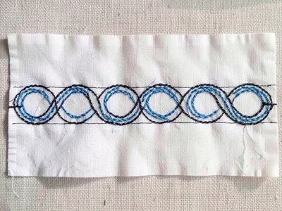 Ainu band fragment — detached embroidered strip showing complete repeating motif
