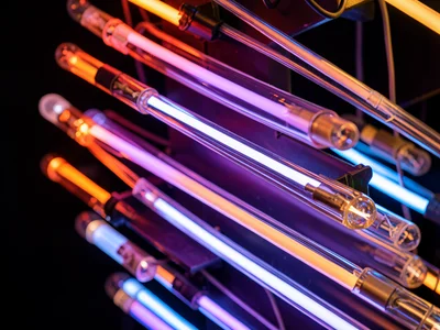 A cascade of neon tubes in a gallery installation: multiple parallel tubes creat