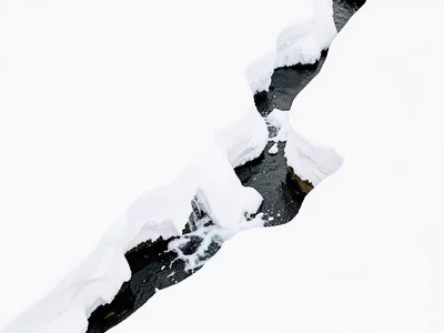 Stream emerging from snow visible