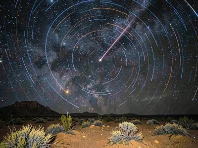Meteor crossing star trail field