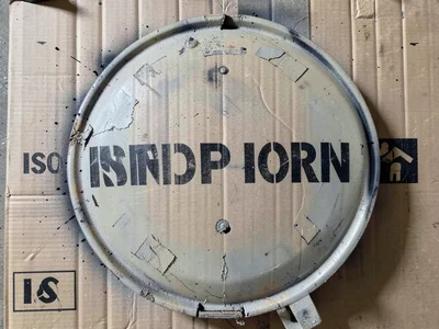 A cement mixer truck drum with the company name in large stenciled letters wrapp