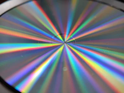 DVD data surface at steep angle, rainbow diffraction splitting overhead light in