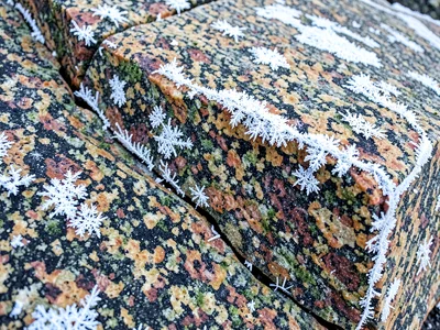 Winter frost in granite cracks white