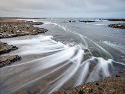 Tidal flat with water movement as soft white