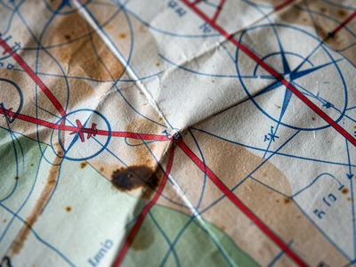 A macro photograph of a 1920s aviation chart, the airway routes marked as bold r
