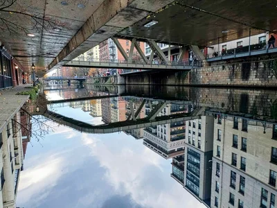 Bridge reflected in urban waterway