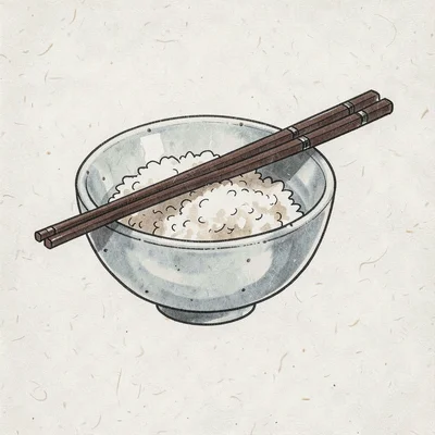 Ceramic bowl of rice with two chopsticks resting across the rim