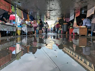 Market stalls in wet ground reflection