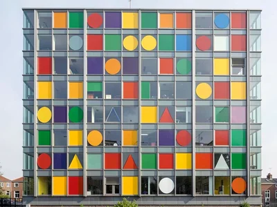 Glass building facade — repeating rectangle grid with primary color window panel