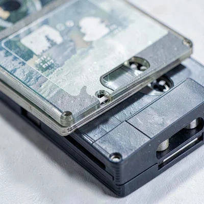 Mineral-cut macro of a stack of cassette cases with cool shadow valleys between 