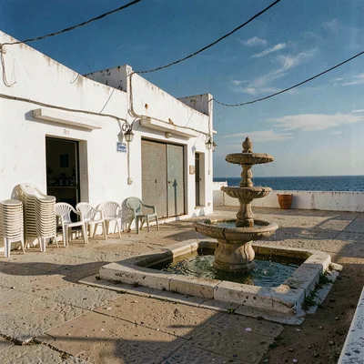 Mediterranean summer photograph, August dry heat, An empty village square at sie