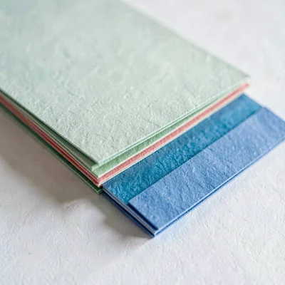 Paper macro sidebar of a stacked pair of color-coated paper samples fanned sligh