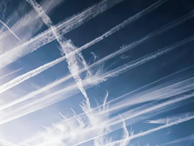 Cirrus wisps arranged in parallel streaks across gradient sky