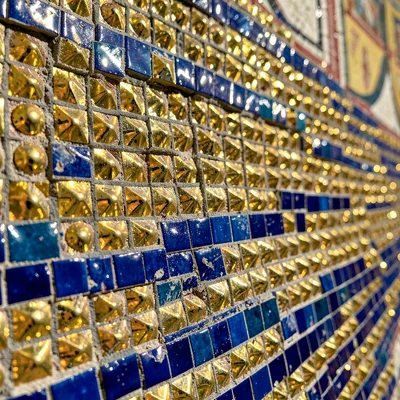 Close-up of a Byzantine wall mosaic — gold tesserae and cobalt blue tiles in tig