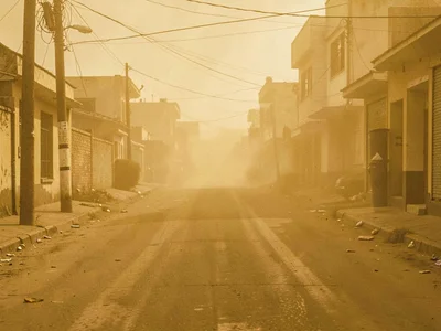 Street scene rendered in ochre monotone by dust filter