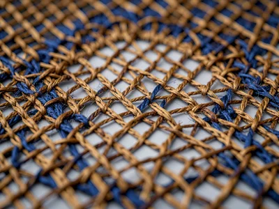 Leno weave of ramie pairs warp threads dyed walnut-brown creating diamond mesh a