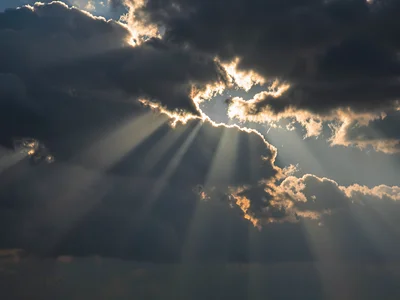 Crepuscular rays revealing atmospheric depth through cloud gaps