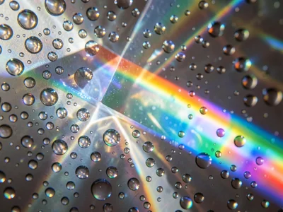 Prism spectrum projected onto a wall of tiny water droplets from a humidifier, e