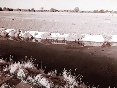 River with white banks dark water