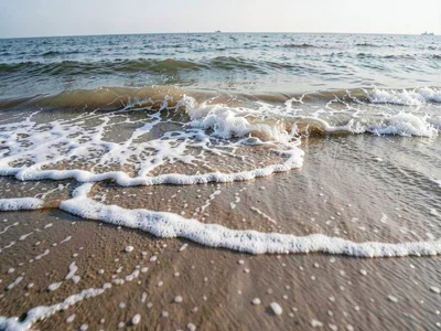 Beach shoreline showing full tide cycle compressed into layered water lines